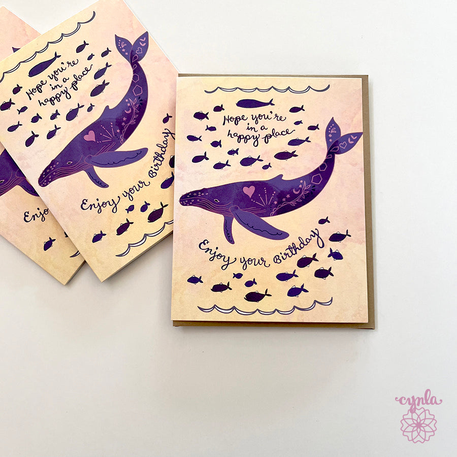 Birthday card with purple whale design and text on a light background 